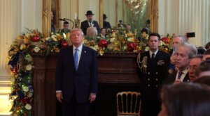 President Donald Trump (L) looks on during a Hanukkah Reception in the East Room of the White House on December 16, 2025 in Washington, DC. Trump hosted attendees to celebrate the holiday and the lighting of the menorah on the third night of Hanukkah. 