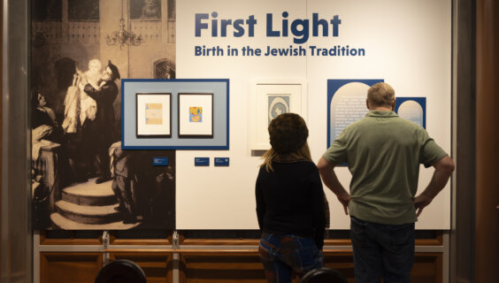 Visitors at the exhibition opening of <i>First Light: Birth in the Jewish Tradition</i>.