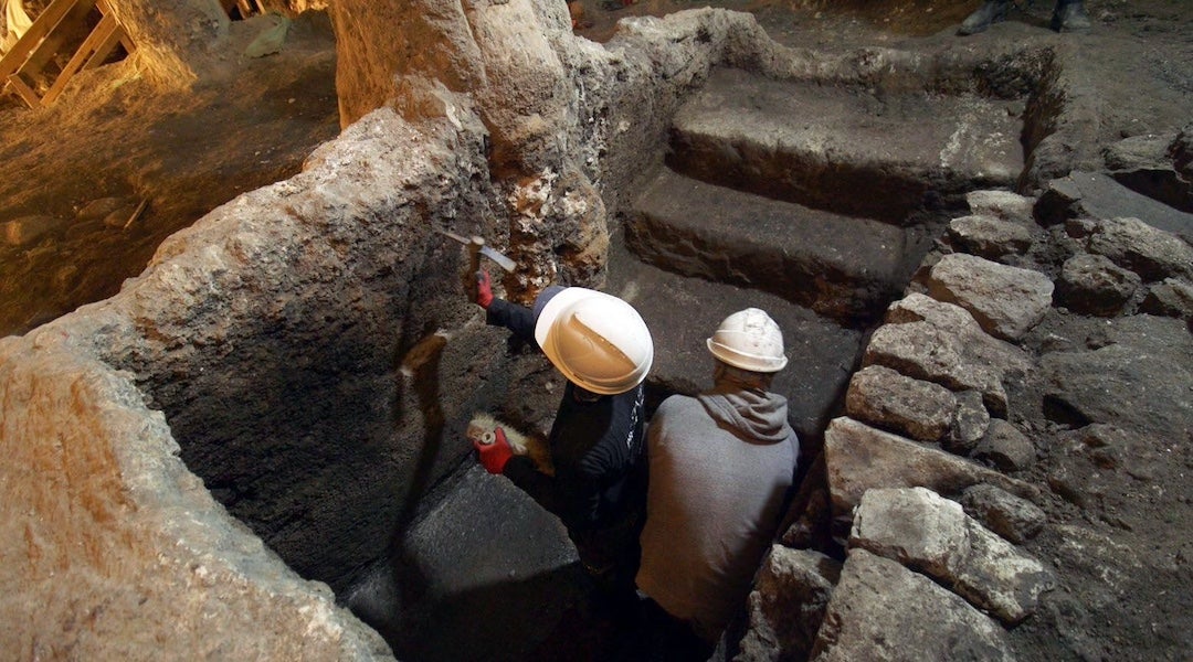 Workers clear debris from the excavation of a Second Temple period ritual bath, or mikveh, in Jerusalem, Dec. 2025. 