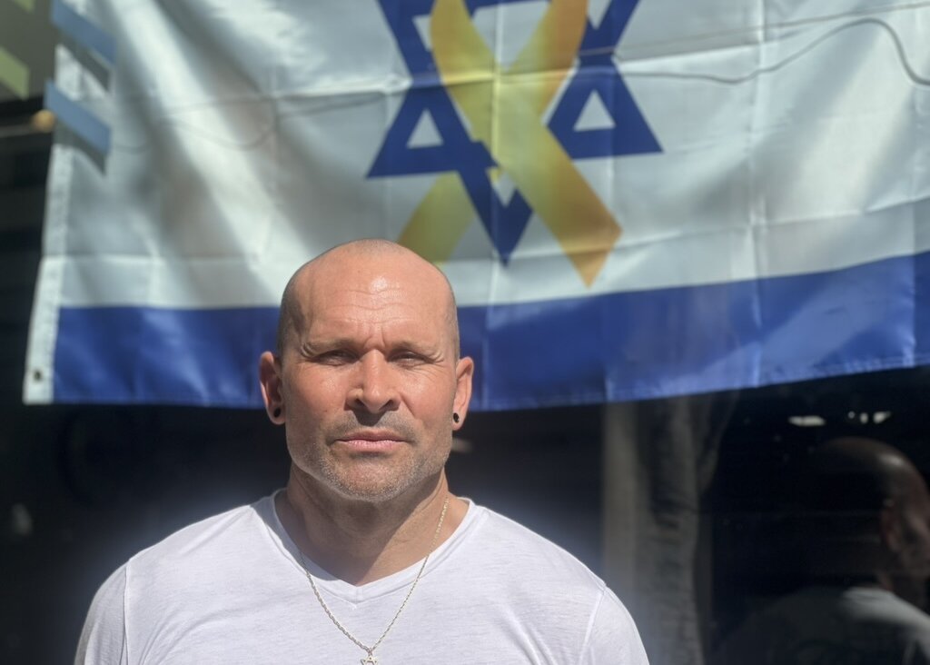 Elon Rubin, an Israeli citizen, hung an Israeli flag in the window of his bike shop after Hamas attacked on Oct. 7, 2023.