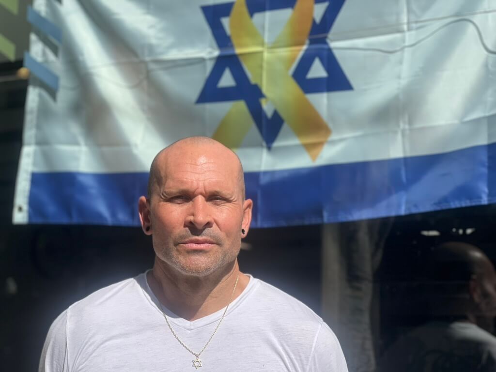 Elon Rubin, an Israeli citizen, hung an Israeli flag in the window of his bike shop after Hamas attacked on Oct. 7, 2023.