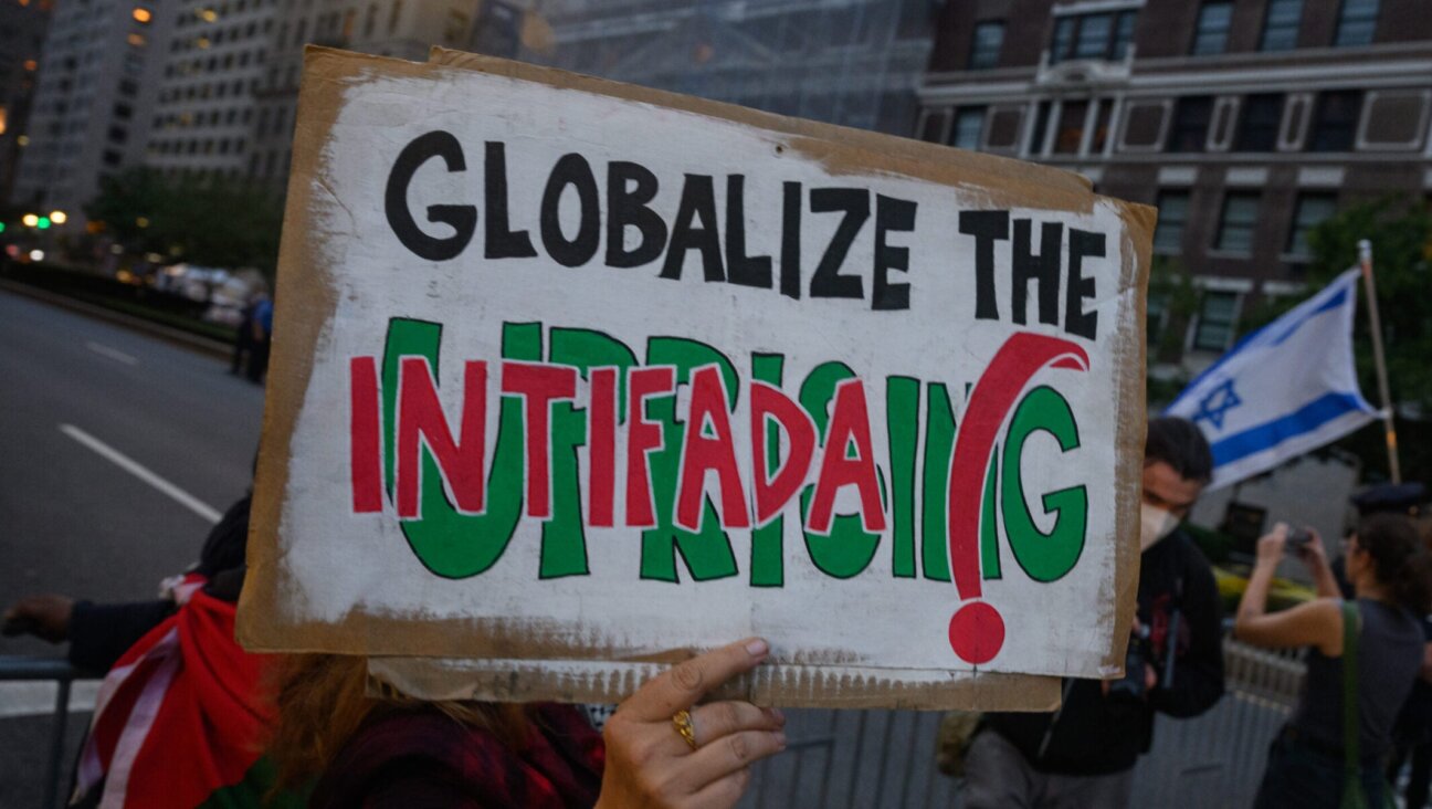 A pro- Palestinian protester holds a “globalize the intifada” sign near during an anti-Israel protest in New York City, Sept. 25, 2025.