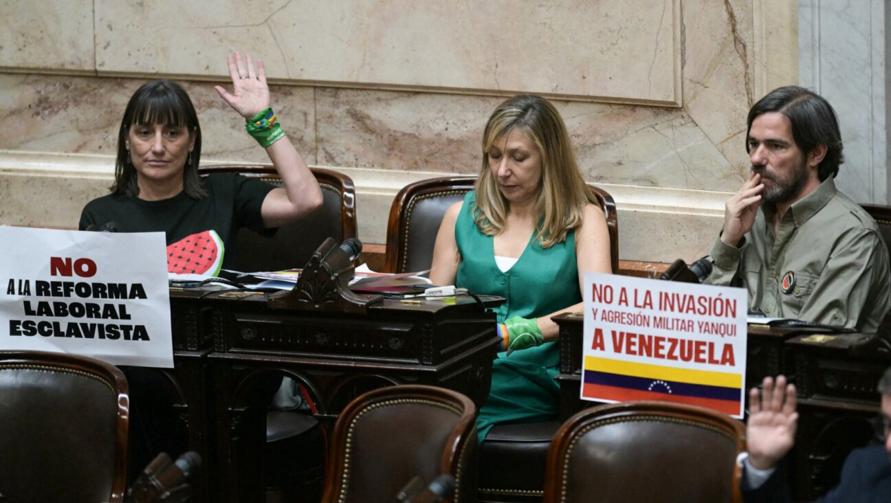 Argentina's Frente de Izquierda deputies Romina del Pla, Miryam Bregman, and Nicolas Del Cano (from left) sit at their desks during the oath ceremony at the Chamber of Deputies of the Argentine Congress in Buenos Aires on Dec. 3, 2025.