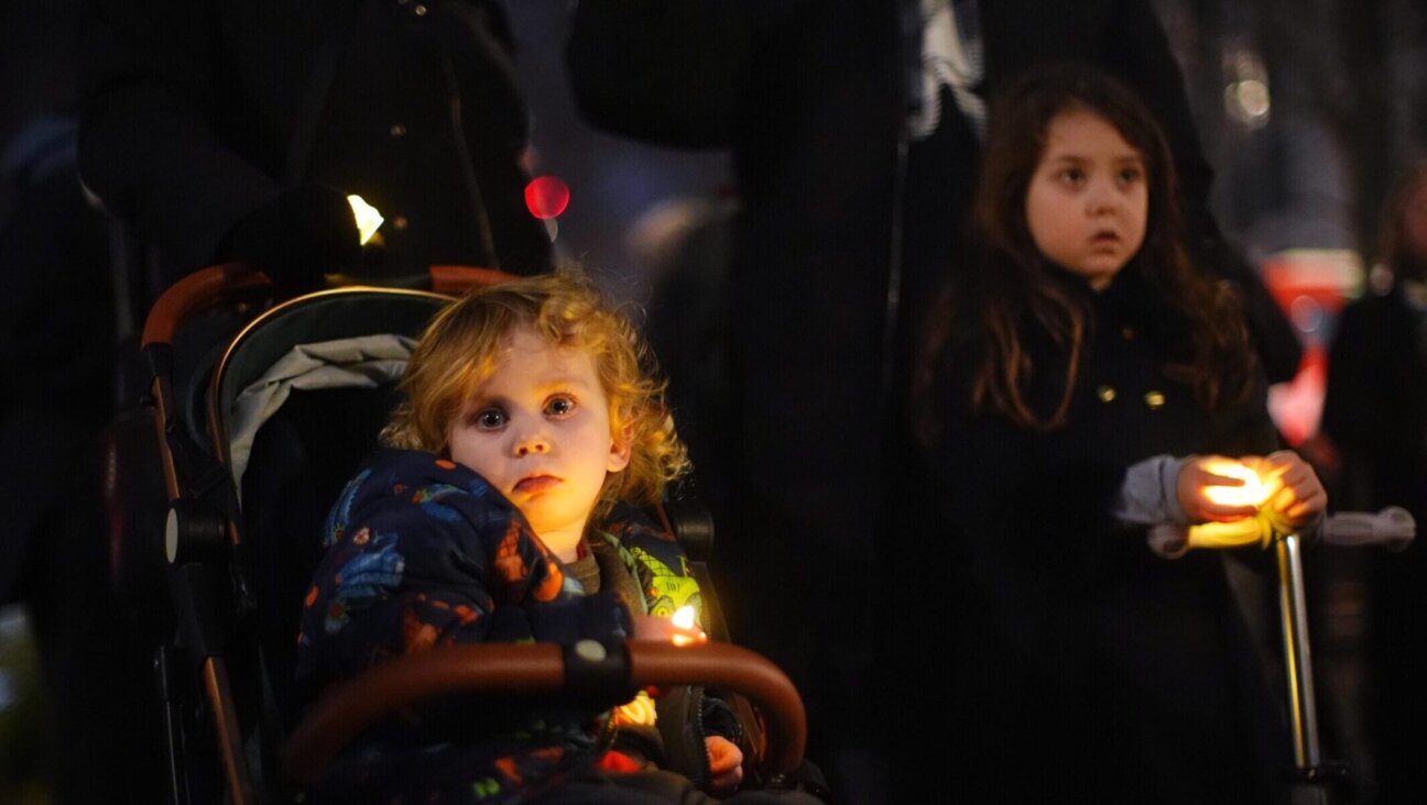 Children attend a vigil outside the Australian High Commission in central London, following the terrorist attack targeting a Jewish celebration at Bondi Beach in Sydney, Australia, on Dec. 14, 2025. 