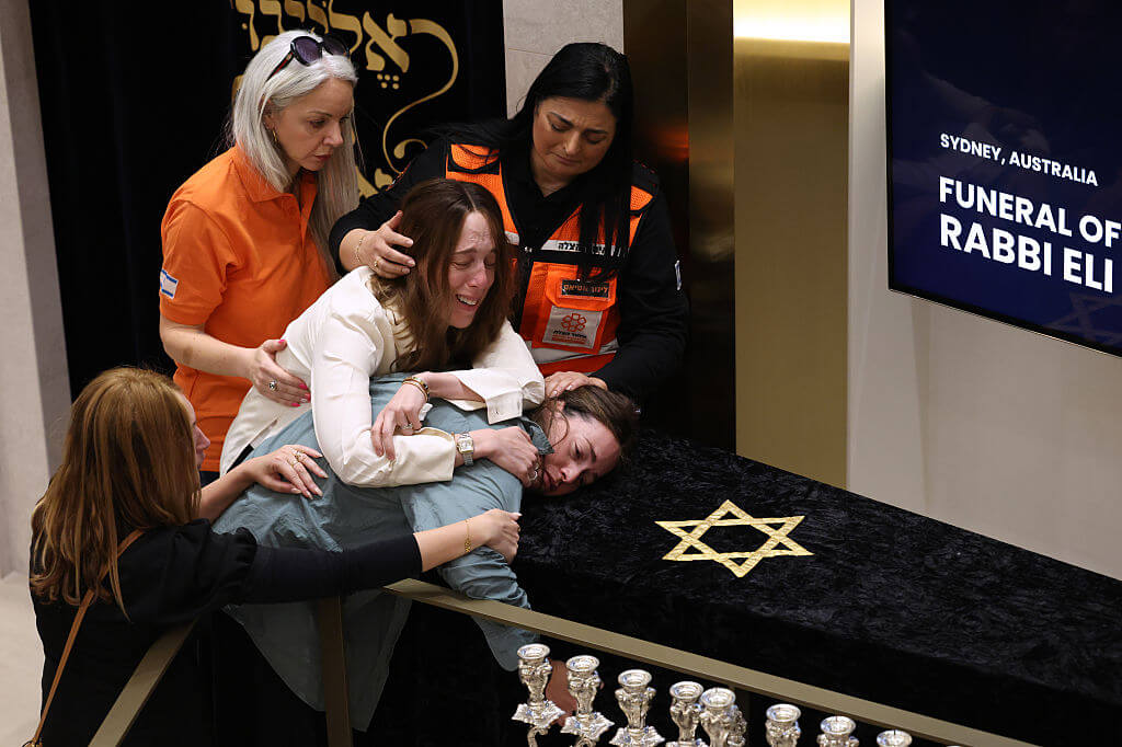 Family grieve at the coffin of Rabbi Eli Schlanger, a victim in the Bondi Beach mass shooting, during his funeral at Sydney's Chabad of Bondi on December 17, 2025.
