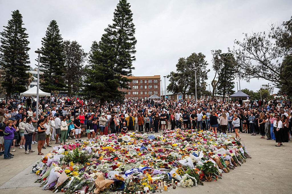 Mourners gather to lay flowers at Bondi Beach in Sydney, Australia. Police say 15 people were killed and more than 40 others injured when two attackers opened fire near a Hanukkah celebration at Bondi Beach.