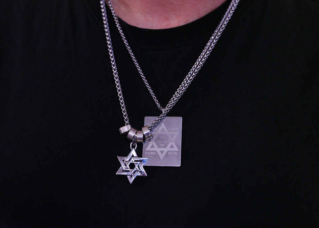 A member of the Jewish community wears necklaces in the shape of the Star of David at Jewish community center, Chabad of Bondi at Bondi Beach on December 15, 2025 in Sydney, Australia.