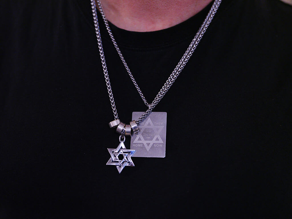 A member of the Jewish community wears necklaces in the shape of the Star of David at Jewish community center, Chabad of Bondi at Bondi Beach on December 15, 2025 in Sydney, Australia.