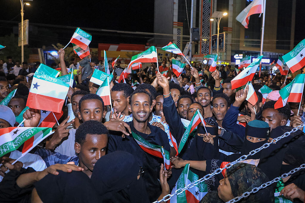 Residents wave Somaliland flags as they gather to celebrate Israel's announcement recognizing Somaliland's statehood in downtown Hargeisa. (Photo by Farhan Aleli / AFP via Getty Images)