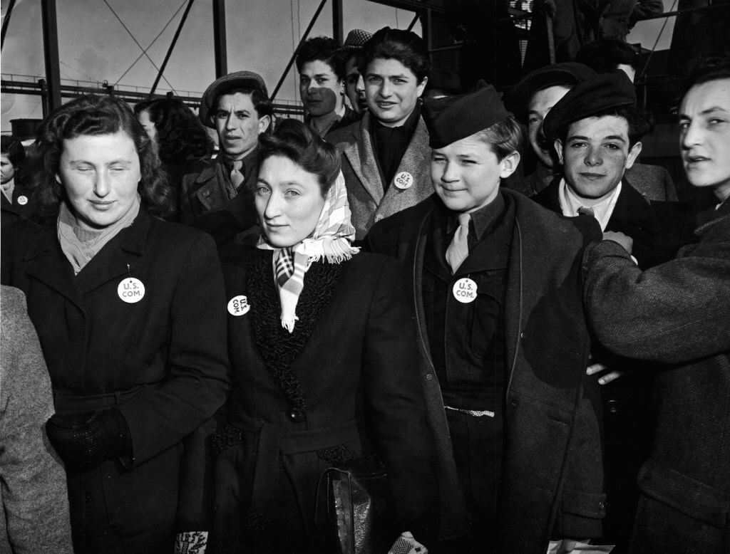 A group of unidentified children and young adults stands on the deck of the S.S. Marine Perch as it arrives in the United States bringing immigrants and World War II refugees from Europe, to New York, likely February 1947.