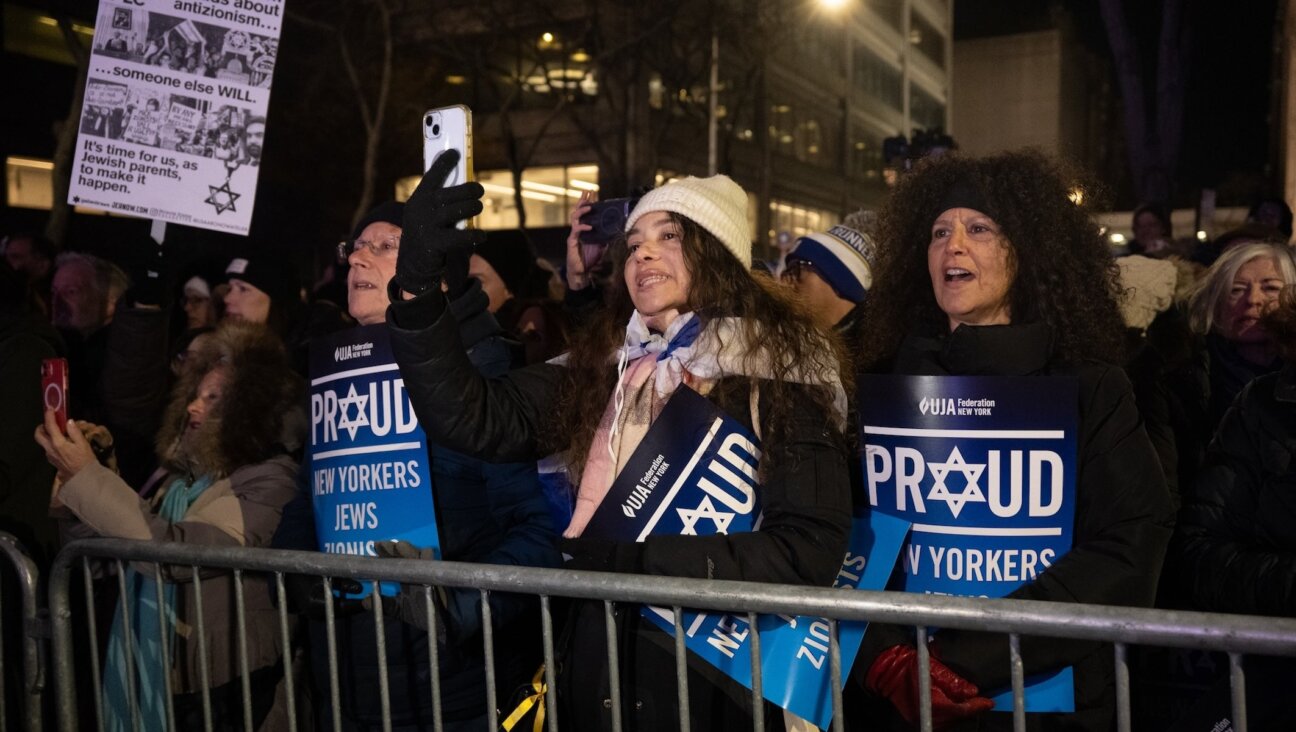 Rally-goers held signs distributed by UJA-Federation of New York, and braved the 30-degree weather outside Park East Synagogue, Dec. 4, 2025. 