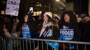 Rally-goers held signs distributed by UJA-Federation of New York, and braved the 30-degree weather outside Park East Synagogue, Dec. 4, 2025. 