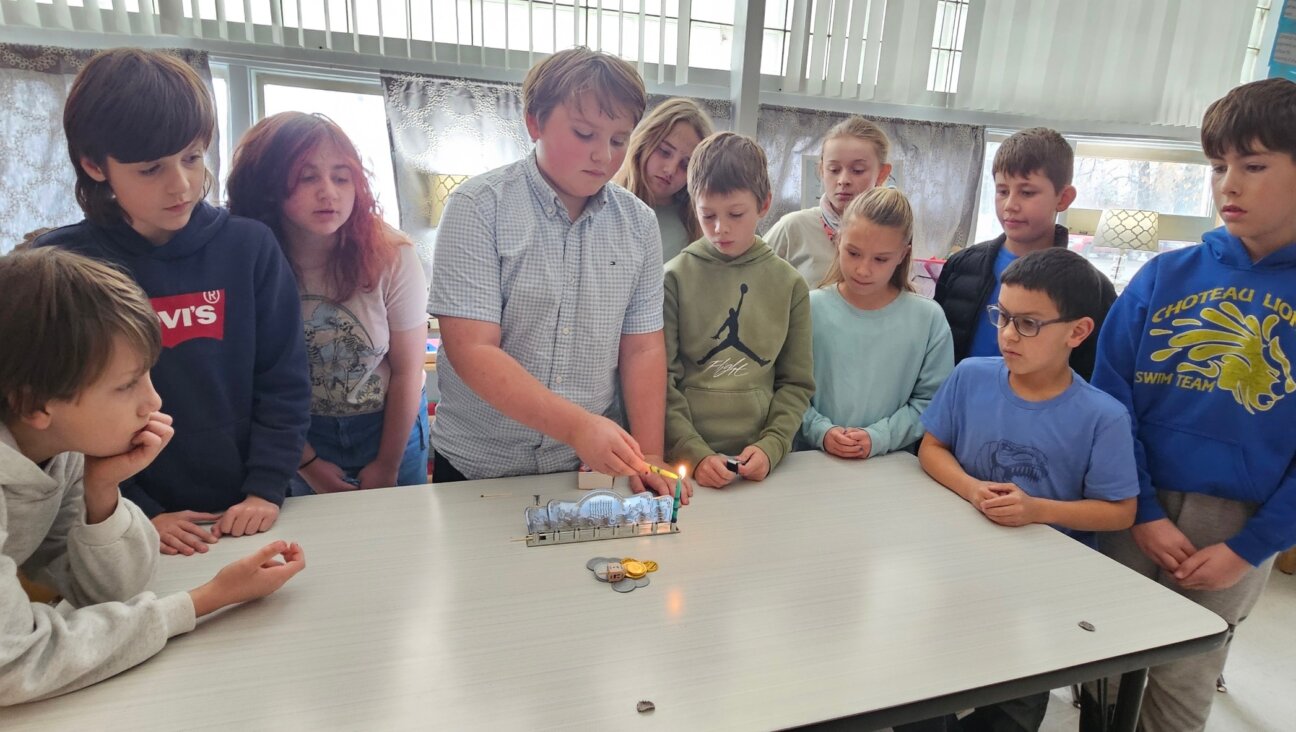 Students at Choteau Elementary light Hanukkah candles. 