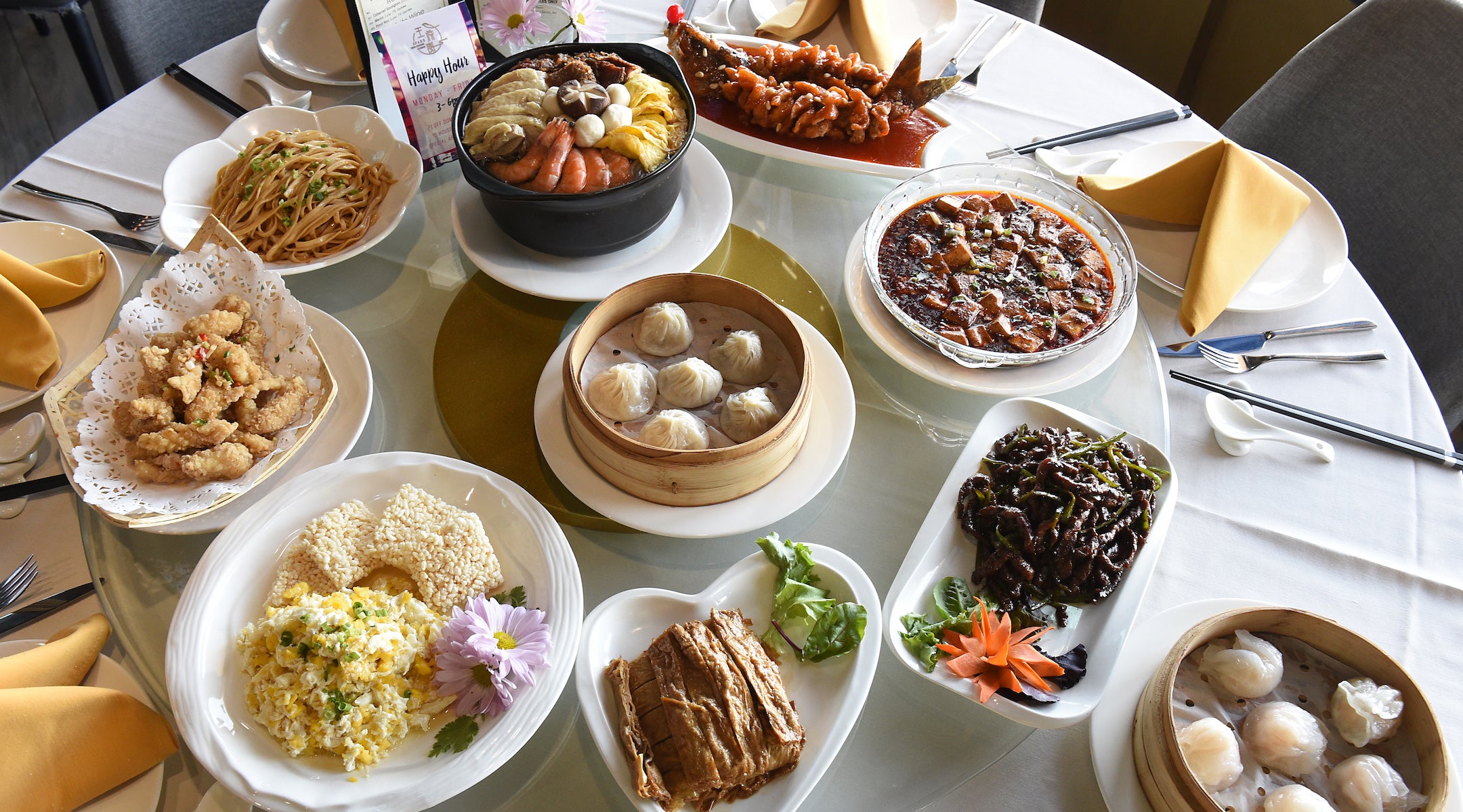 Table with dishes served family style on a rotating centerpiece at SparX Fine Chinese Cuisine in Halfmoon, New York.