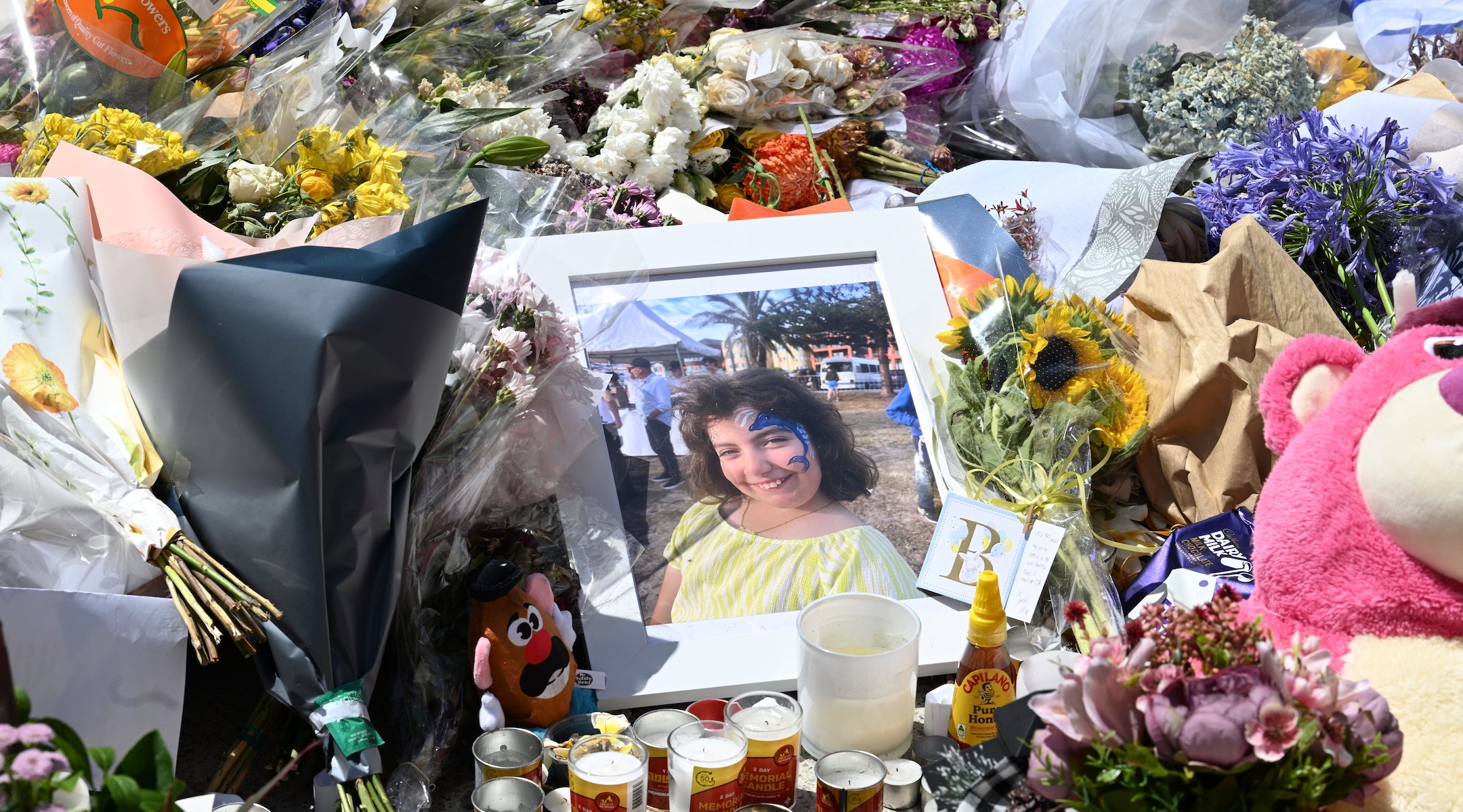 A portrait of 10-year-old Matilda, victim of the Bondi Beach shooting, sits on a flower memorial beside Bondi Pavilion on December 17, 2025 in Sydney, Australia.