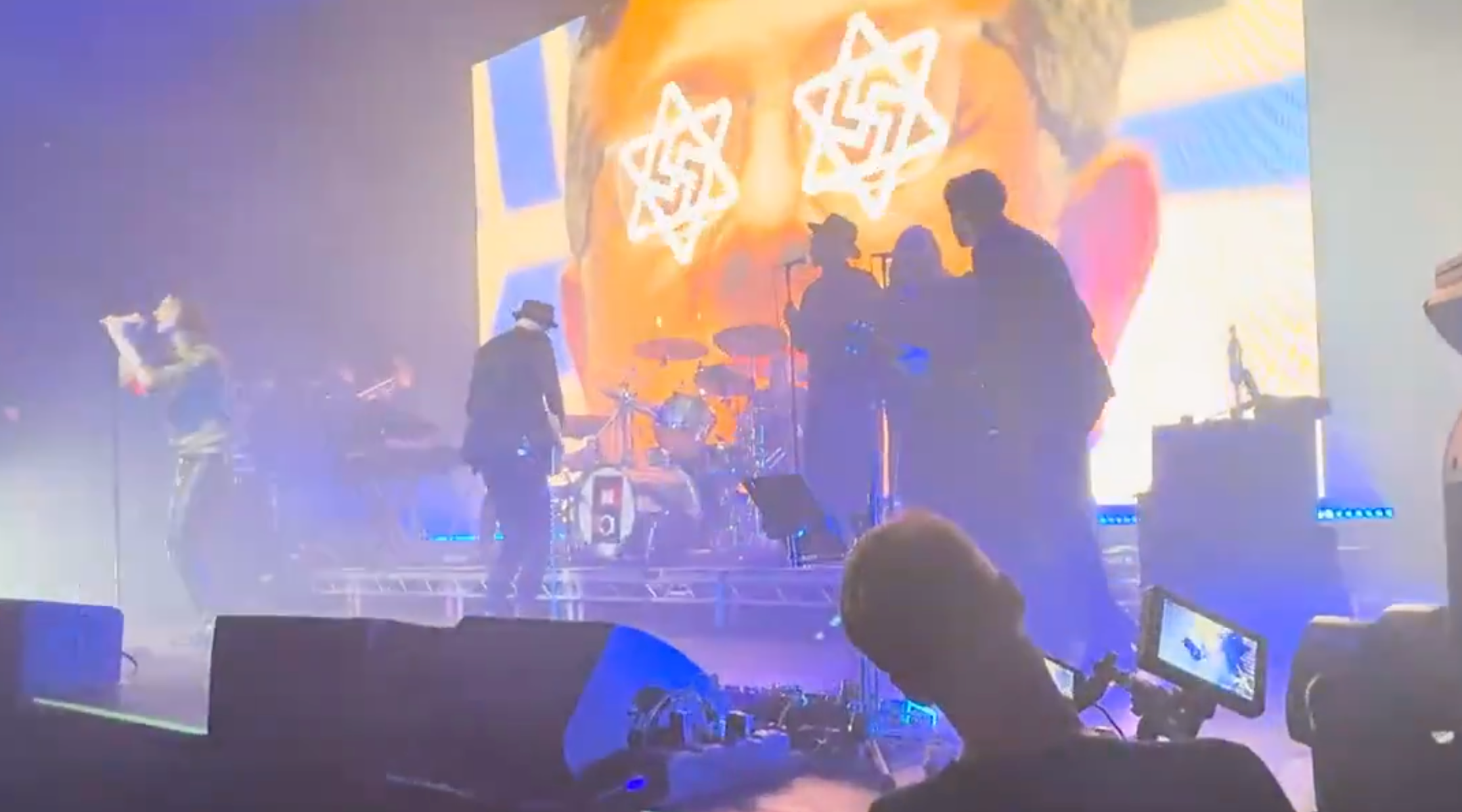 Bobby Gillespie of Primal Scream performs onstage in front of a display featuring a swastika-Star of David hybrid during a concert at the Roundhouse music venue on Dec. 08, 2025 in London, England.