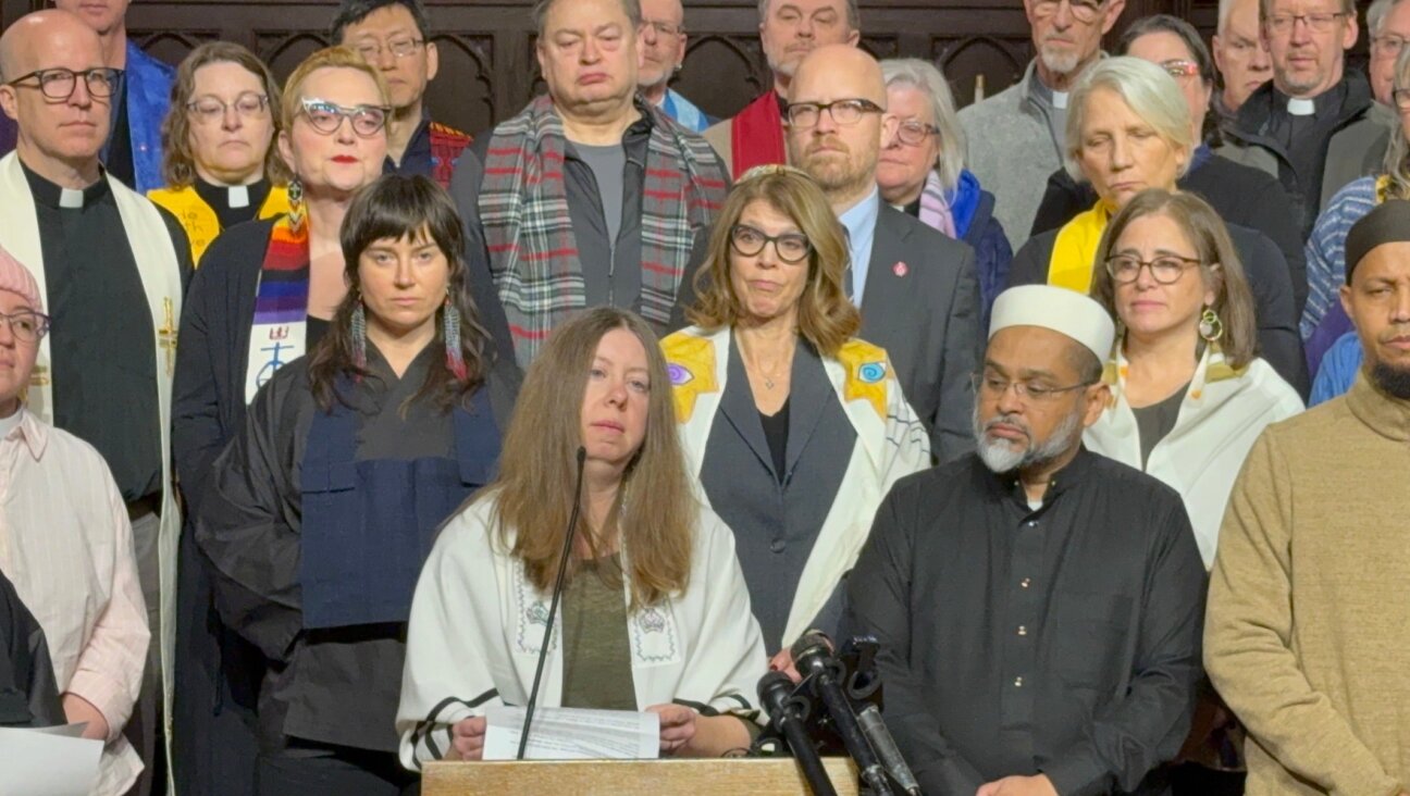 Rabbi Tamar Magill-Grimm, of the Conservative Beth Shalom Congregation in Mendota Heights, Minnesota, speaks out with other faith leaders against Immigrations and Customs Enforcement operations in the Twin Cities at a press conference at a Lutheran church in St. Paul, Jan. 20, 2026. Local cantors Tamar Havilio and Rachel Stock Spilker are behind Magill-Grimm to the right.