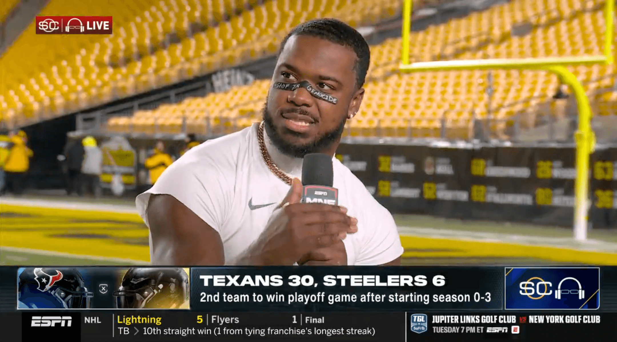 Azeez Al-Shaair, a longtime pro-Palestinian advocate, answers a postgame question while donning the message “STOP THE GENOCIDE” on his eye black, Jan. 12, 2026. (Screenshot via YouTube)