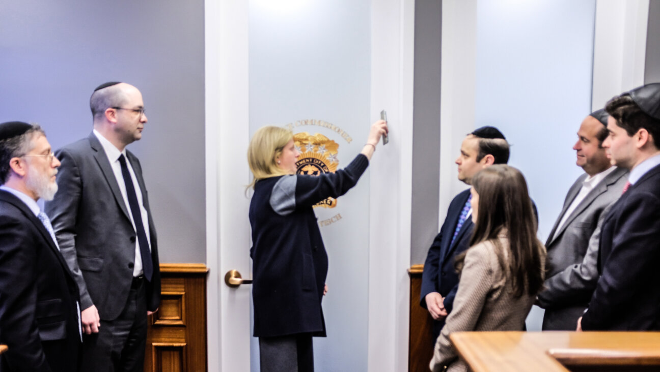 NYPD Commissioner Jessica Tisch placing a mezuzah at her office on Jan. 27. 