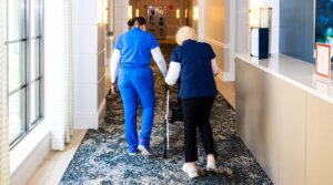 A staff member assists a resident of the Sinai Residences in Boca Raton, Florida, on June 6, 2025.