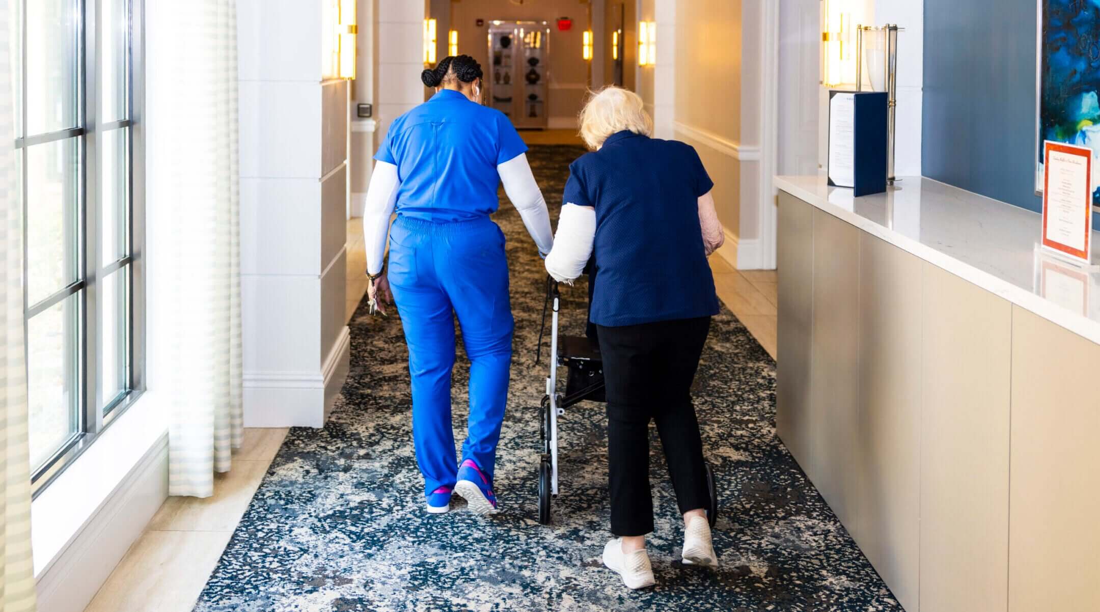 A staff member assists a resident of the Sinai Residences in Boca Raton, Florida, on June 6, 2025.