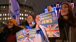 British Jews pose in front of a large menorah as they gather for a Hanukkah event in Trafalgar Square in central London, Dec. 16, 2025.