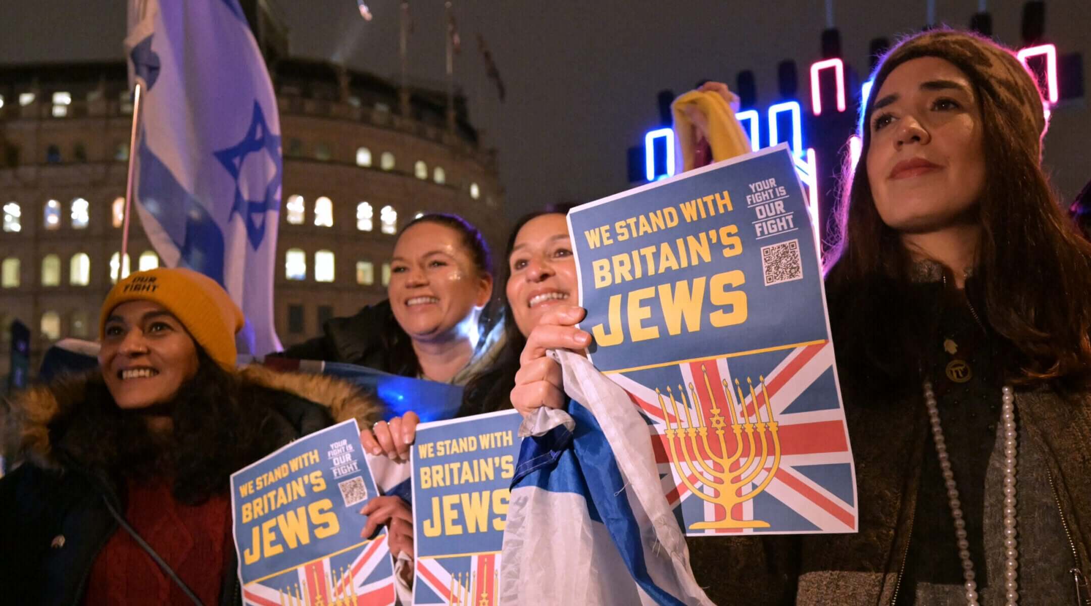 British Jews pose in front of a large menorah as they gather for a Hanukkah event in Trafalgar Square in central London, Dec. 16, 2025.
