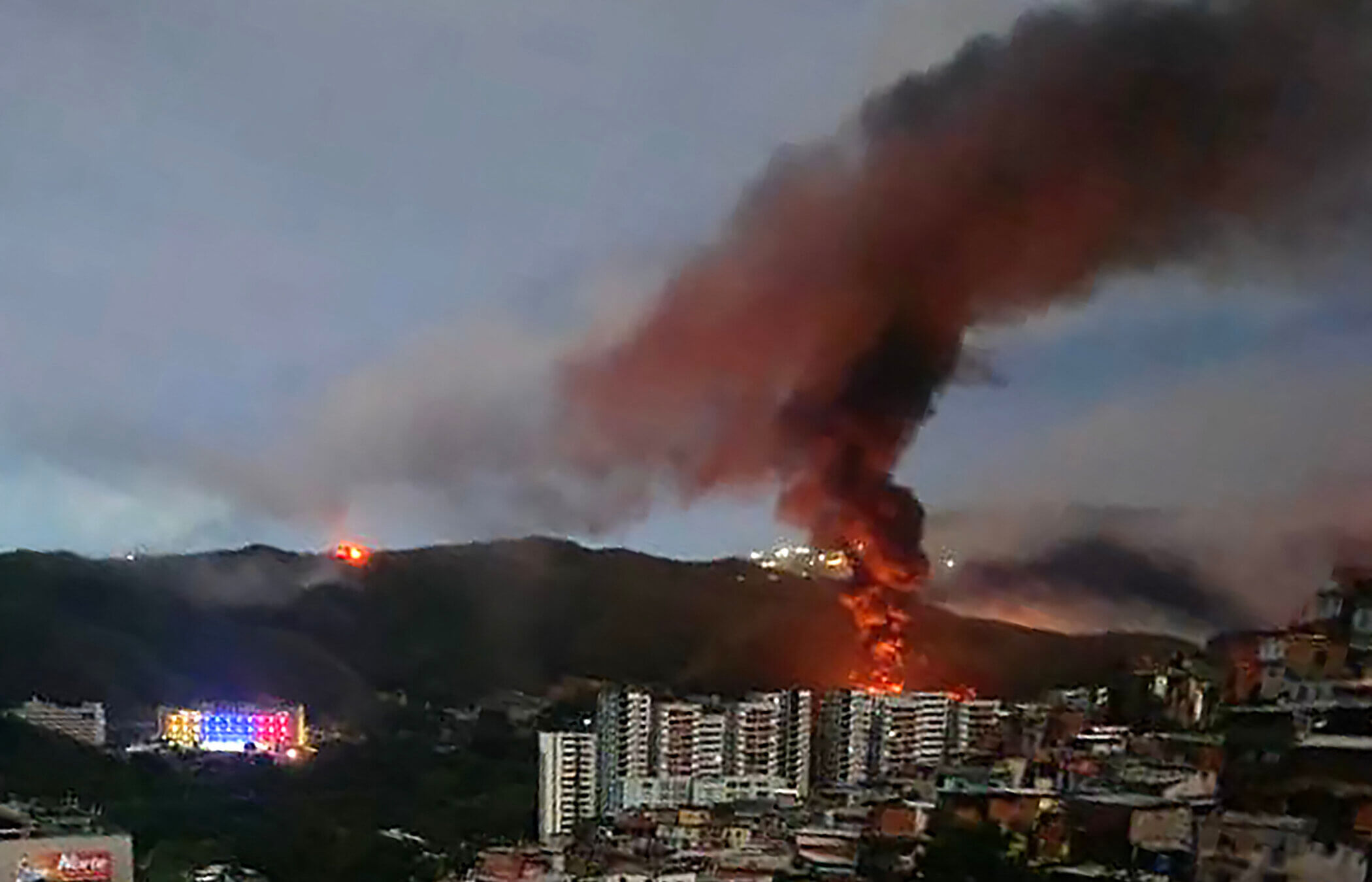 Fire at Fuerte Tiuna, Venezuela's largest military complex, is seen from a distance after a series of explosions in Caracas Jan. 3.