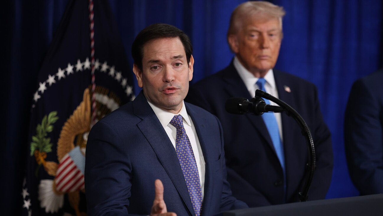 Secretary of State Marco Rubio speaks during a press conference as U.S. President Donald Trump listens at Mar-a-Lago club on January 03, 2026, in Palm Beach, Florida. During the event, President Trump confirmed that the U.S. military carried out a large-scale strike in Caracas overnight, resulting in the capture of Venezuelan leader Nicolas Maduro and his wife, Cilia Flores. 