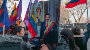 A protester holds Nicolas Maduro’s portrait during a demonstration against Maduro’s capture in front of the U.S. Embassy on January 4, 2026 in Madrid, Spain. 