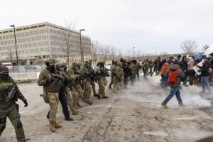 Federal agents shoot pepper balls at protestors outside an ICE facility during a protest against U.S. Immigration and Customs Enforcement (ICE), Jan. 11, 2026. 