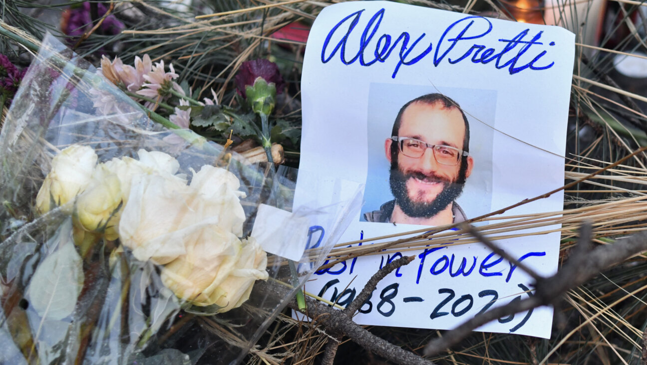 Flowers are left at a makeshift memorial for Alex Pretti.