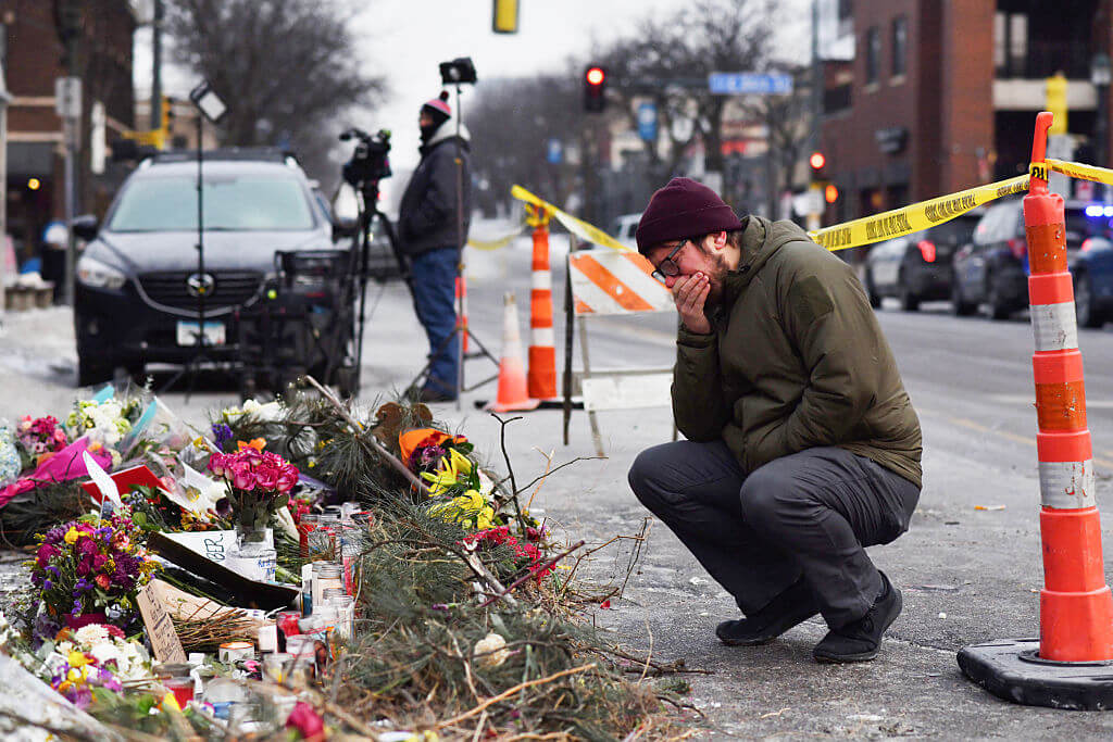 A mourner visits a makeshift memorial on January 25, in the area where Alex Pretti was killed in Minneapolis, Minnesota.