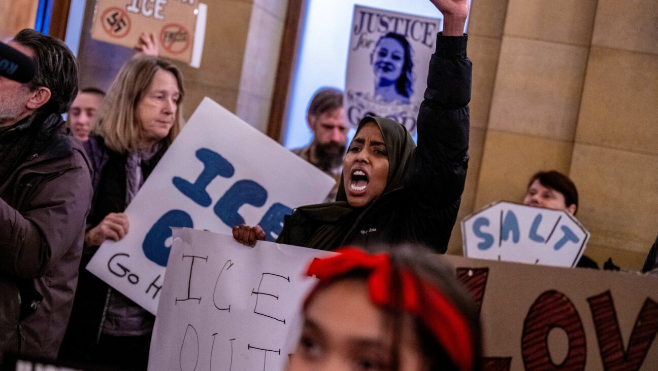 Protesters shout slogans against ICE officers outside of the office of Minnesota Governor Tim Walz.