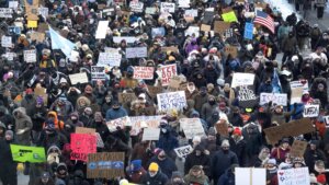 Demonstrators march through downtown Minneapolis protesting ICE operations and the death of Renee Good and Alex Pretti.