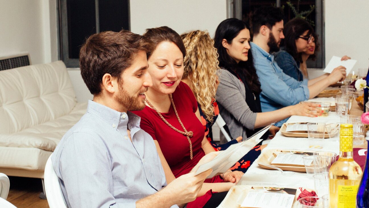 People gather at a OneTable Shabbat dinner. 