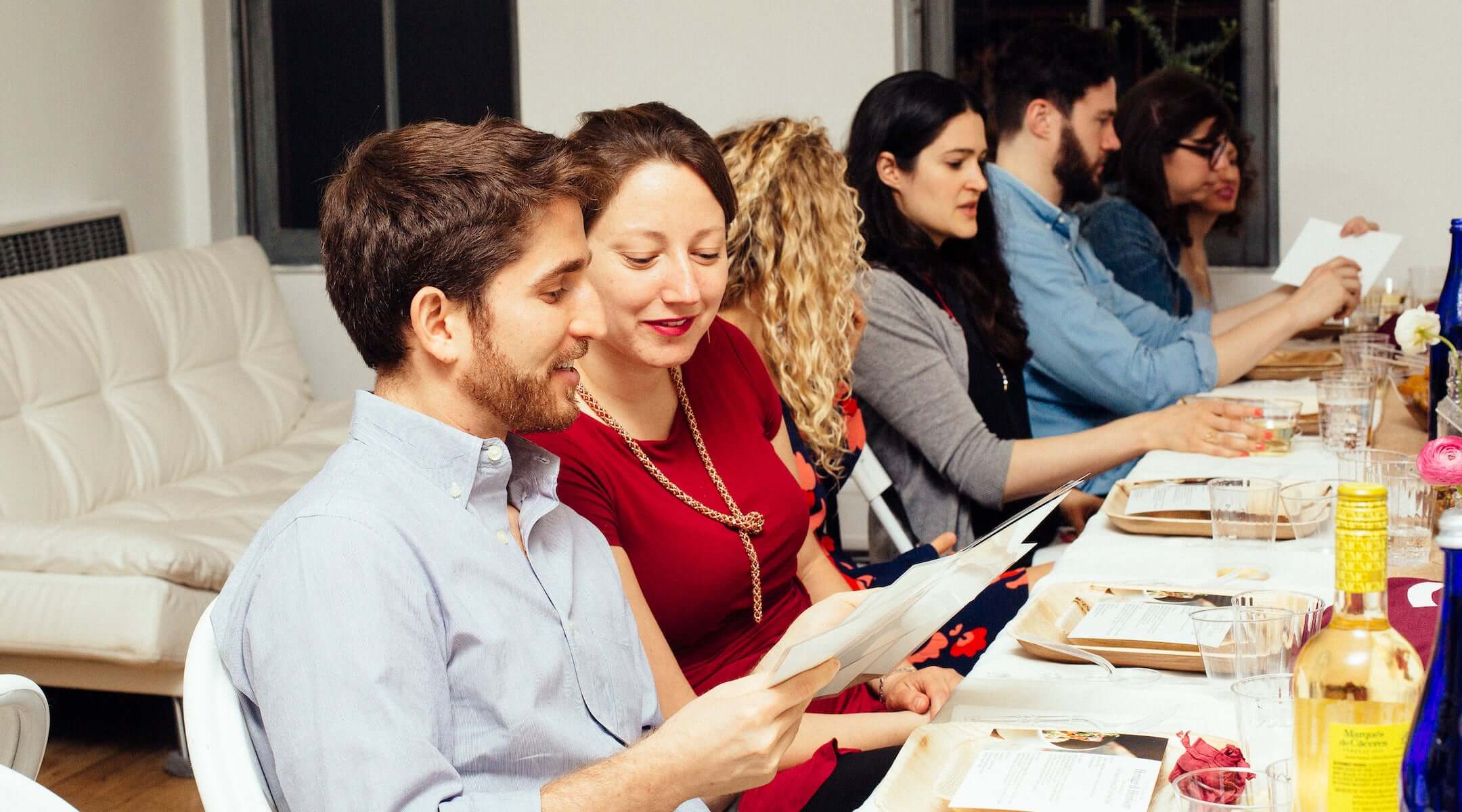 People gather at a OneTable Shabbat dinner. 