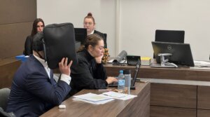 A rabbi and defendant in a court case appears in the district court in Tiergarten, Berlin, Jan. 16, 2026. His attorney, Galina Rolnik, sits next to him. 