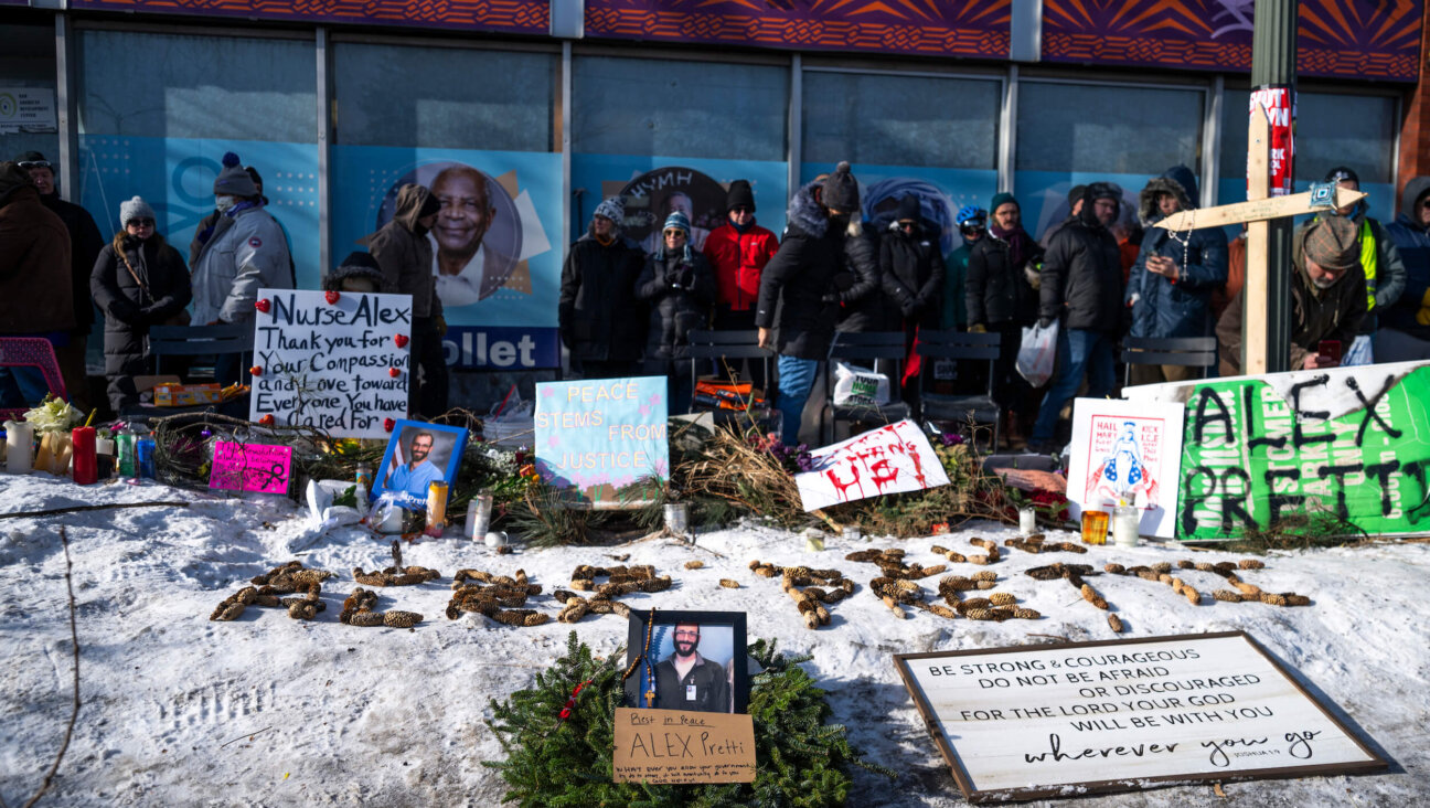People gather during a vigil held by healthcare workers at a memorial for Alex Pretti on Jan. 25 in Minneapolis, Minnesota.