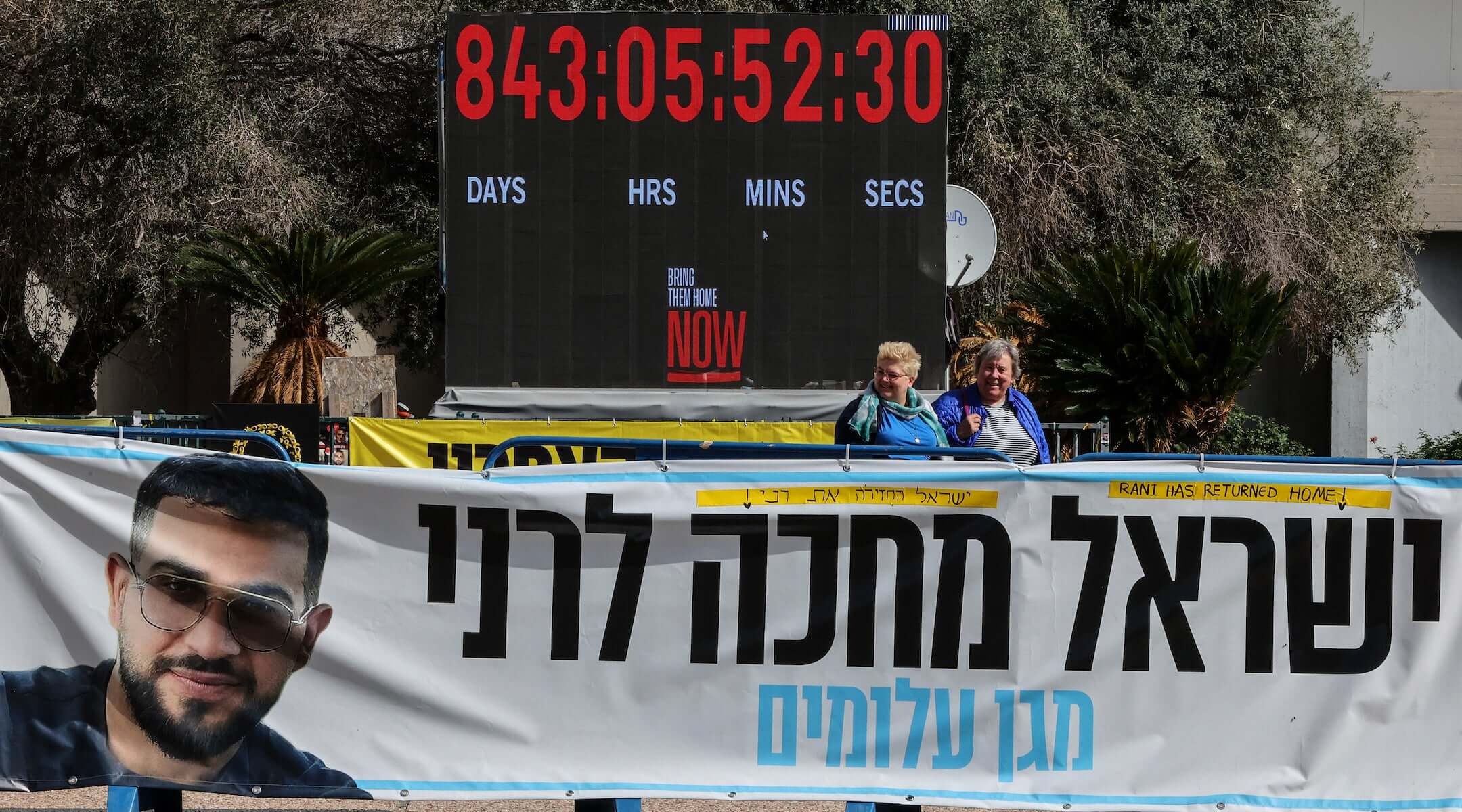 A photograph shows a banner bearing a portrait Ran Gvili, the last hostage held in Gaza, the day after his remains were brought home by Israeli forces, in Hostage Square in Tel Aviv on Jan. 27, 2026.
