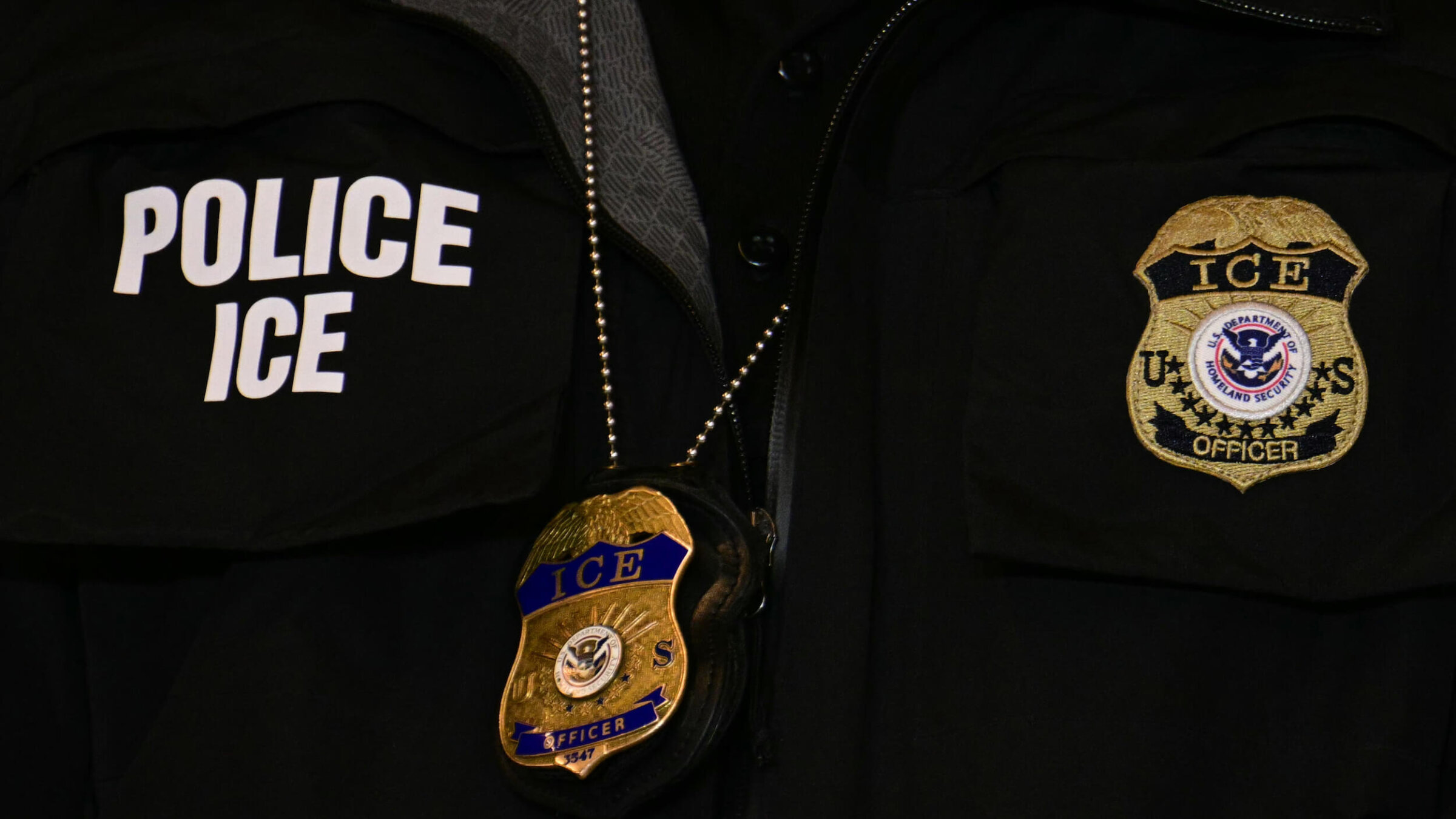 An ICE patch and badge are seen on a Department of Homeland Security agent.