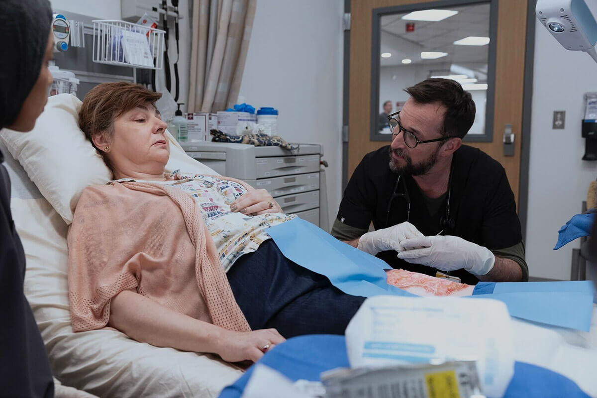 Irina Dubova, left, and Noah Wyle in a scene from "The Pitt." Dubova portrays a survivor of the Tree of Life synagogue shooting who is still experiencing trauma years later.