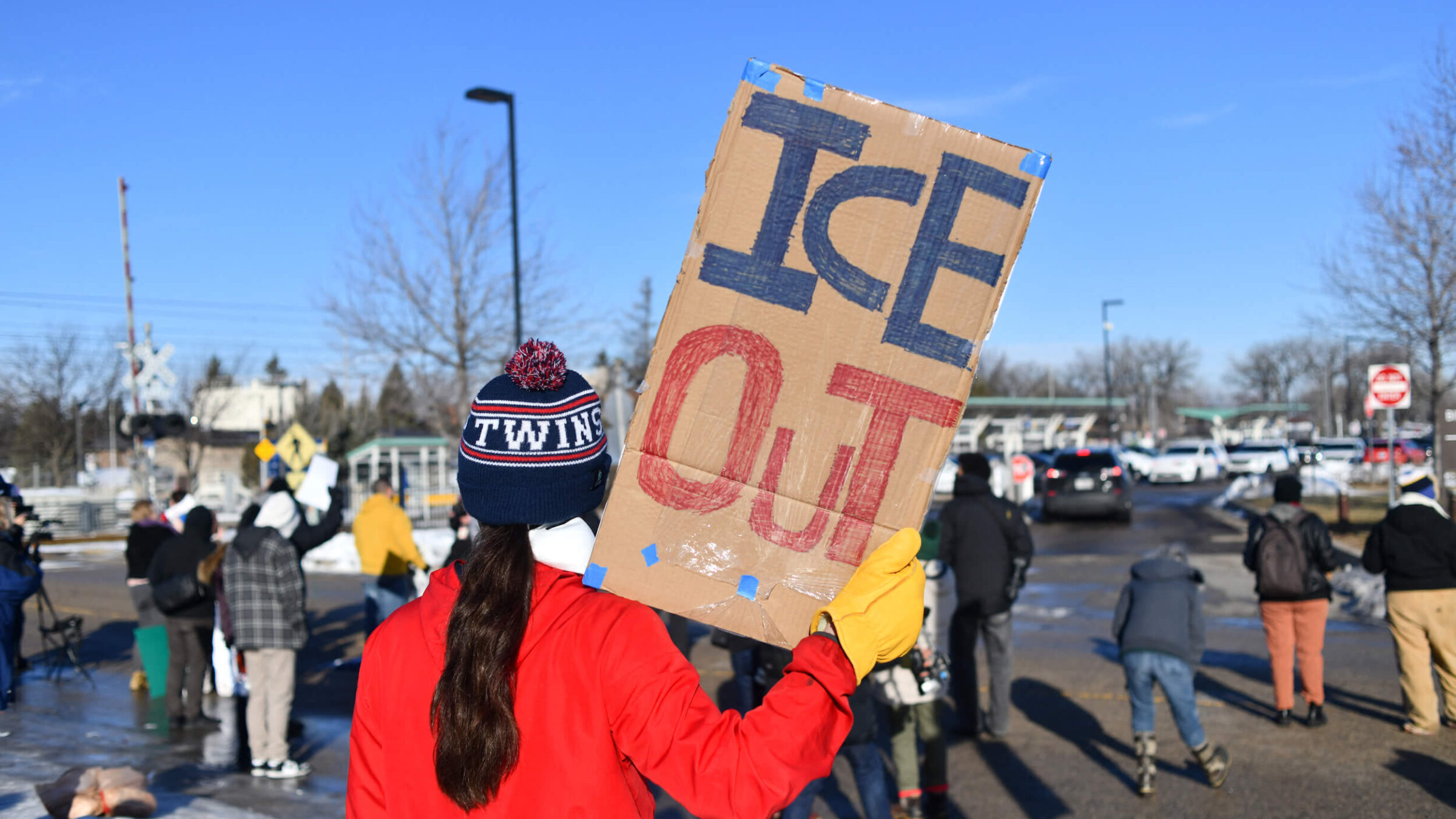 A protester holds a sign outside the Bishop Henry Whipple Federal Building during a demonstration over the fatal shooting of Renee Good by a US Immigration and Customs Enforcement agent, in Minneapolis, Minnesota, on Jan. 9.