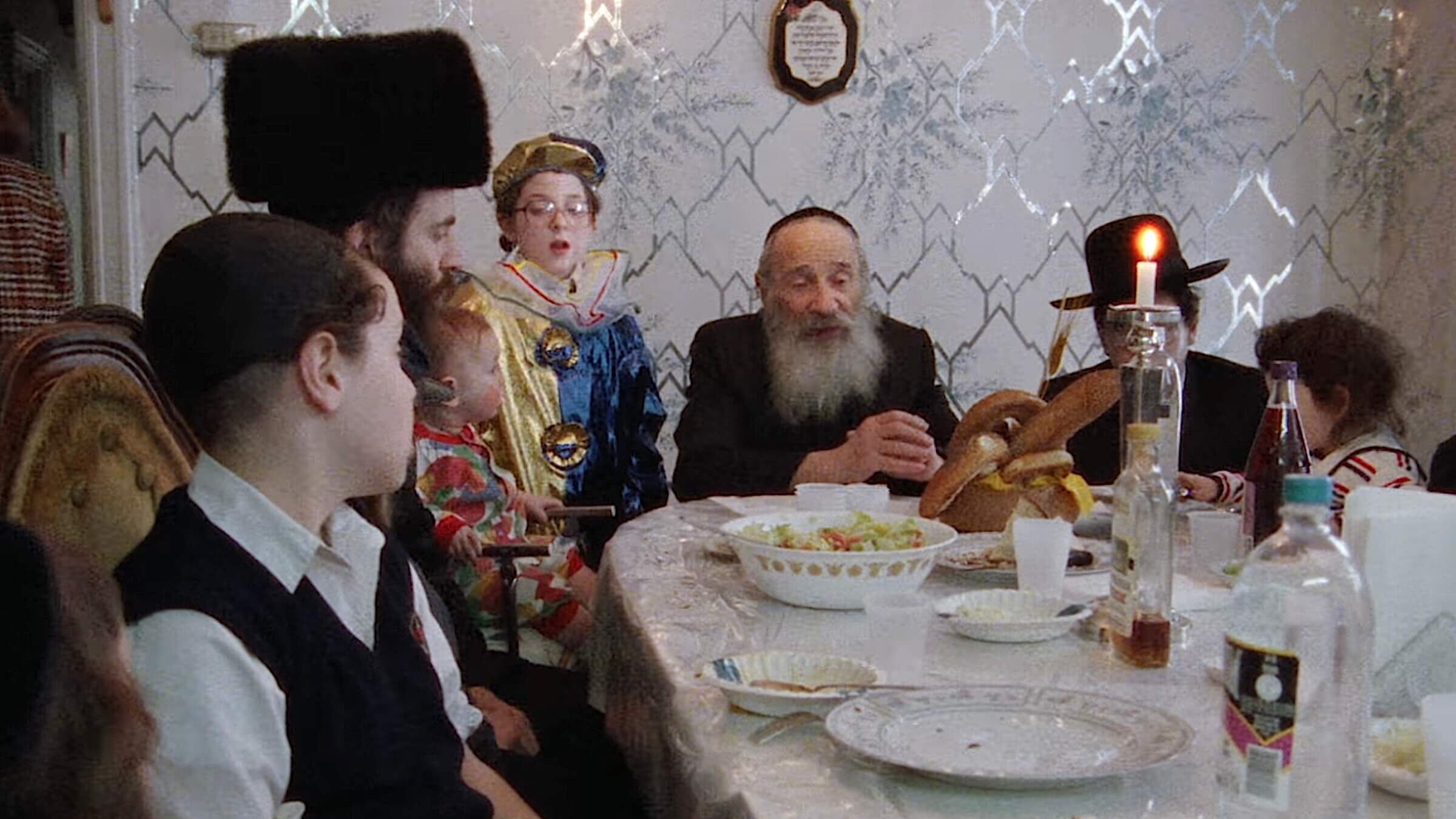 A scene in Yiddish of a Hasidic family celebrating Purim.