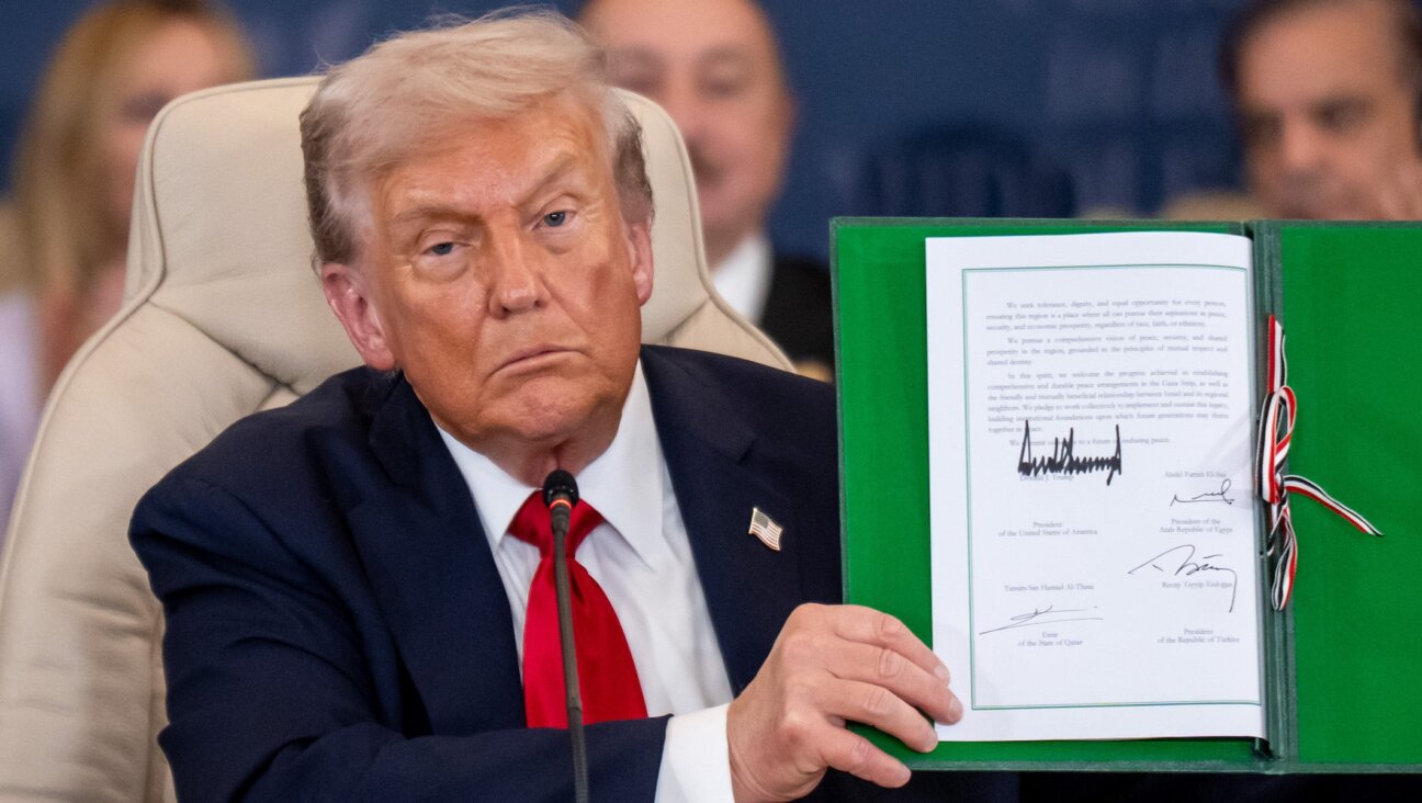 President Donald Trump shows the signed peace treaty at the Gaza summit chaired by Egypt’s President Al-Sisi on Oct. 14, 2025.