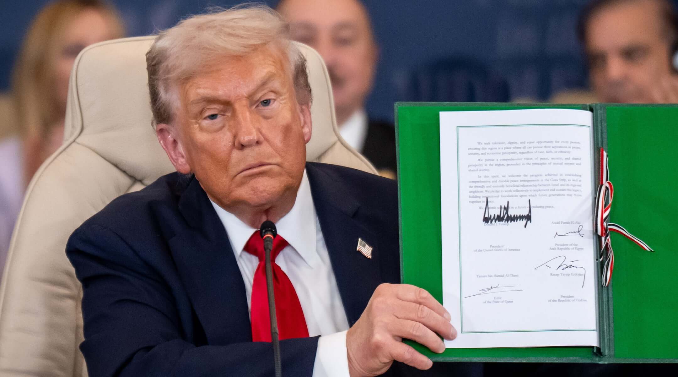 President Donald Trump shows the signed peace treaty at the Gaza summit chaired by Egypt’s President Al-Sisi on Oct. 14, 2025.