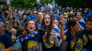 Participants cheer and dance during the Celebrate Israel Parade up Fifth Avenue on May 18, 2025 in New York City.