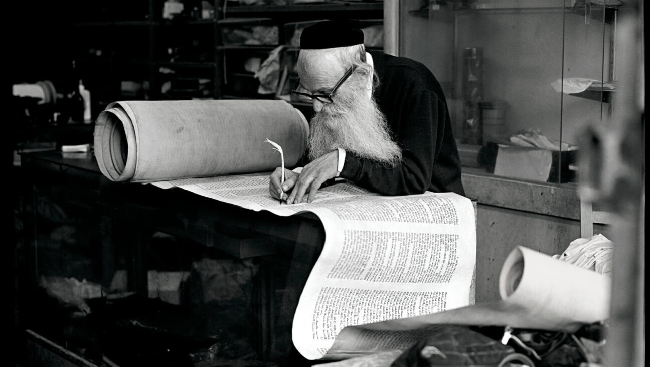 Rabbi Eisenbach, Scribe, Lower East Side, 1975. Aron said the rabbi, who he had been spending time with, had refused to allow his photo to be taken. One day, Aron snapped the photo without asking and, when the rabbi looked over his glasses at the sound of the shutter, ran away. Later, he brought the print to show the scribe, who was delighted by it in the end.