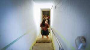 People take cover as siren warns of incoming missiles fired from Iran, at a public bomb shelter in Katzrin, northern Israel, June 19, 2025. 