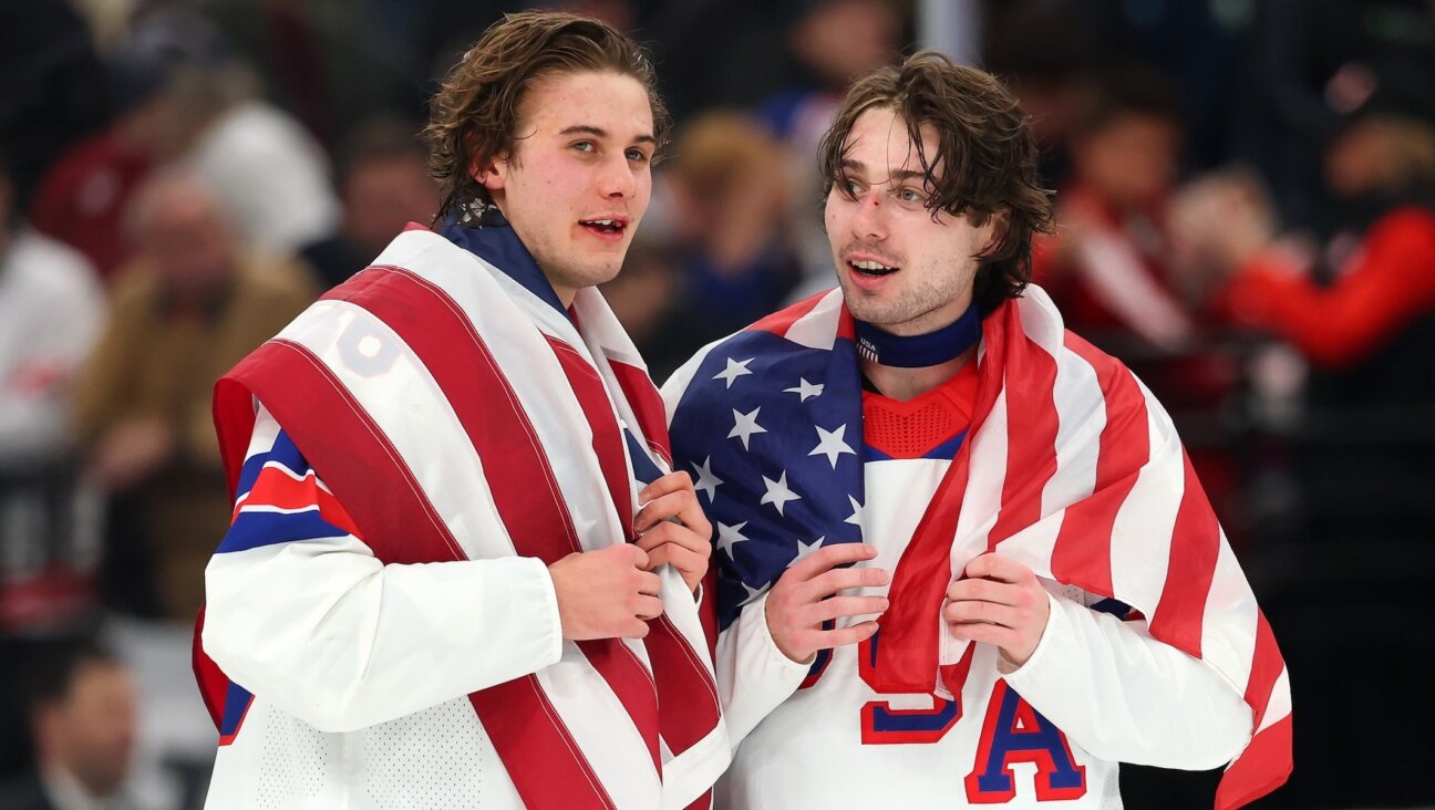 Jack Hughes #86 and Quinn Hughes #43 of Team United States celebrate winning the gold medals after the team’s 2-1 overtime victory in the Men’s Gold Medal match between Canada and the United States of the 2026 Winter Olympic games in Milan, Feb. 22.